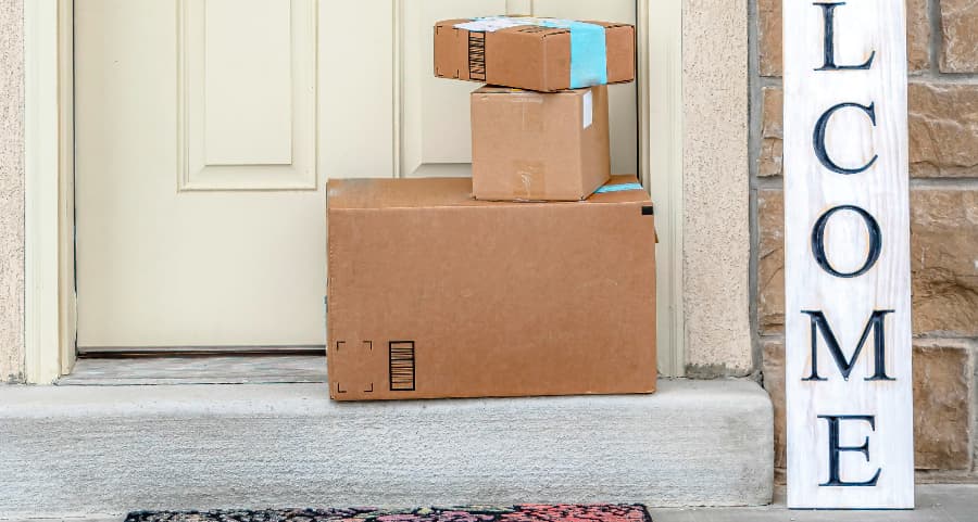 Boxes by the door of a residence with a welcome sign in Sacramento